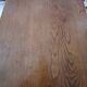 Solid wood dining table with a sculptural base.
