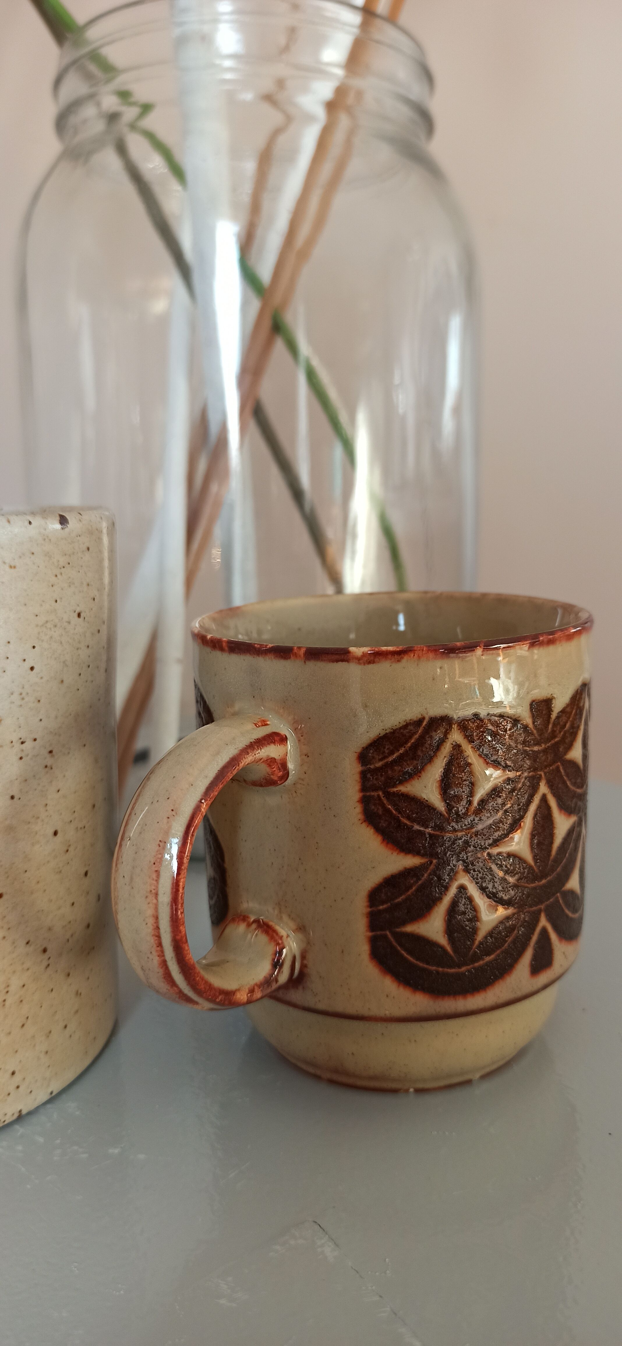 Coffee pot and mug cup in sandstone