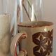 Coffee pot and mug cup in sandstone