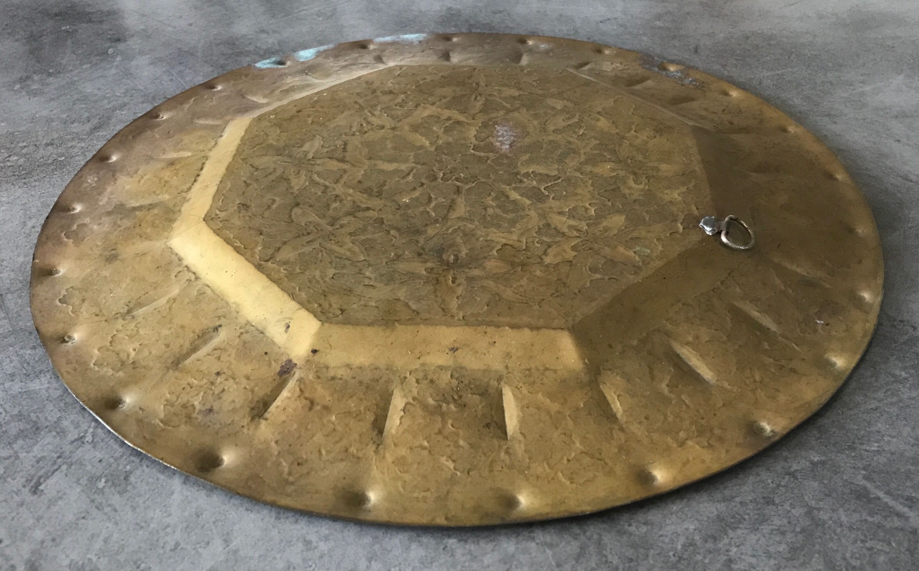 Oriental brass tray with chiseled decoration of arabesques and flowers