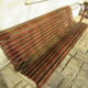 Public bench in wooden slats and cast iron legs