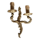 Vintage wall sconce in gold metal with two arms in classic style.