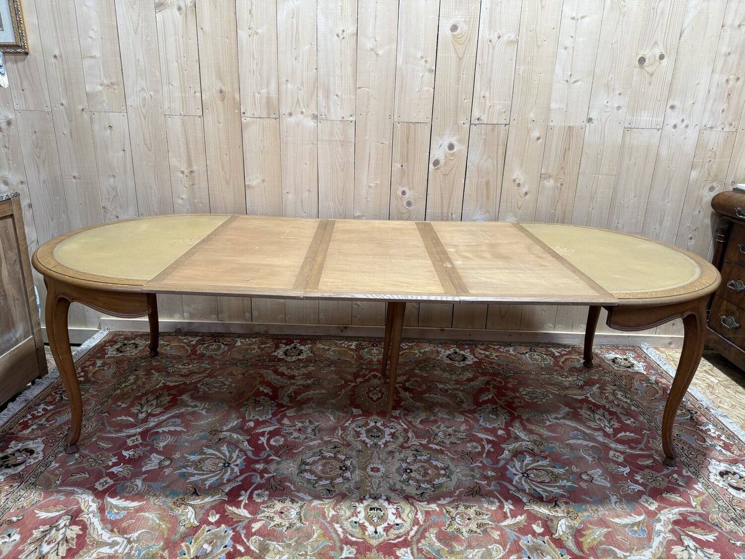 Round oak dining table with leather in Louis XV style.