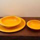 Service of vintage orange plastic plates 70s