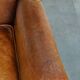 Positively lived-in sheepskin leather wing chair with pleasant seating comfort