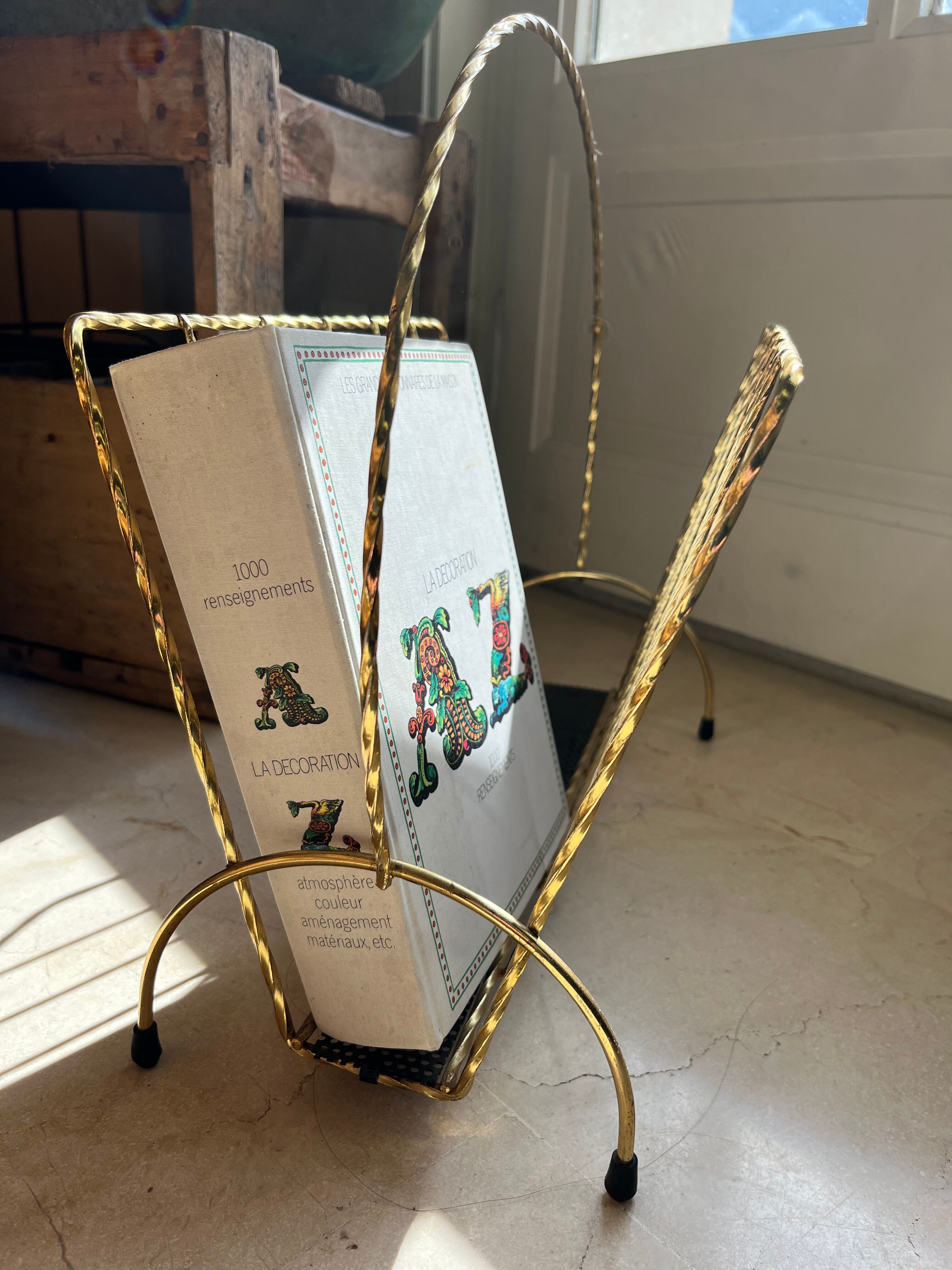 Vintage gold metal magazine rack from the 1960s.