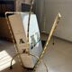 Vintage gold metal magazine rack from the 1960s.