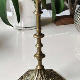 Baroque/Antique style torch candleholder, nineteenth, gilded bronze. Head motifs, volute arabesques