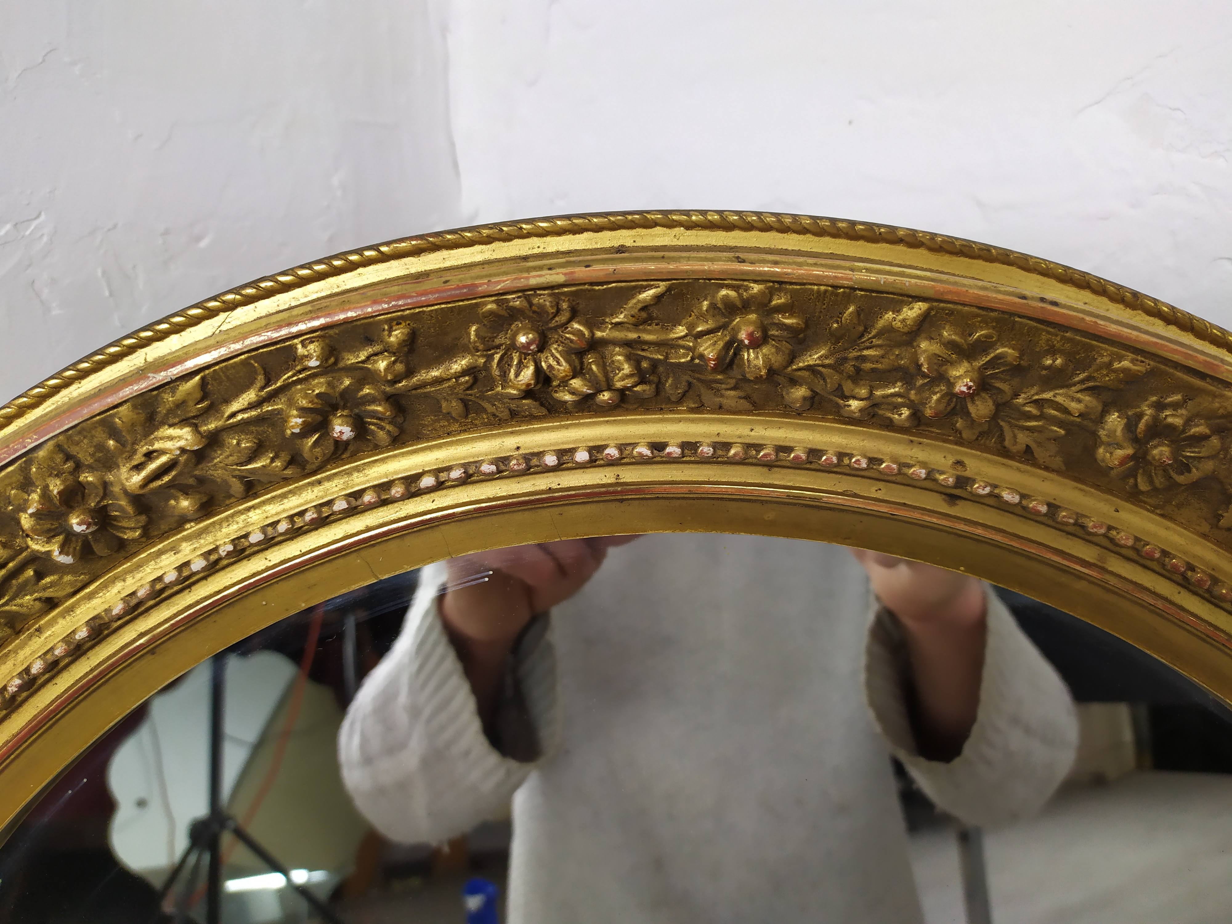 Golden oval mirror