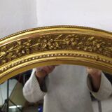 Golden oval mirror