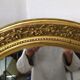 Golden oval mirror