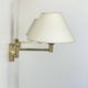 Pair of vintage adjustable wall lights, brass and beige fabric, France, 1970