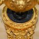 Pair of L'Originale wall sconces plated with 24-carat gold featuring four bronze candles.