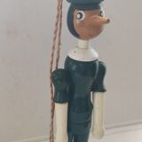 Green pinochio puppet in old wood