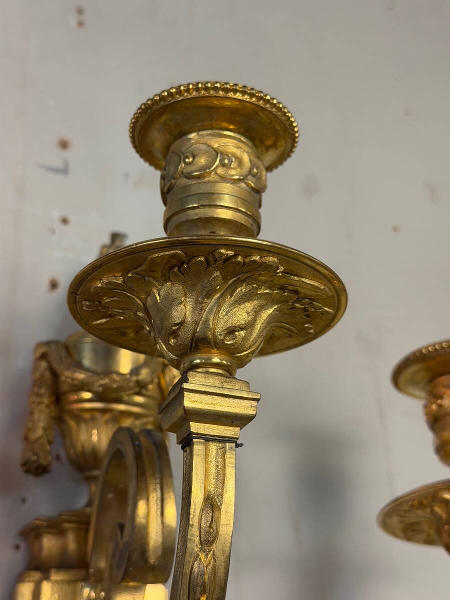 Pair of Louis XVI style wall sconces in gilded bronze, circa 1880.