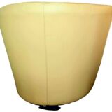 Pair of yellow leather swivel armchairs with asymmetrical armrests, circa 1980