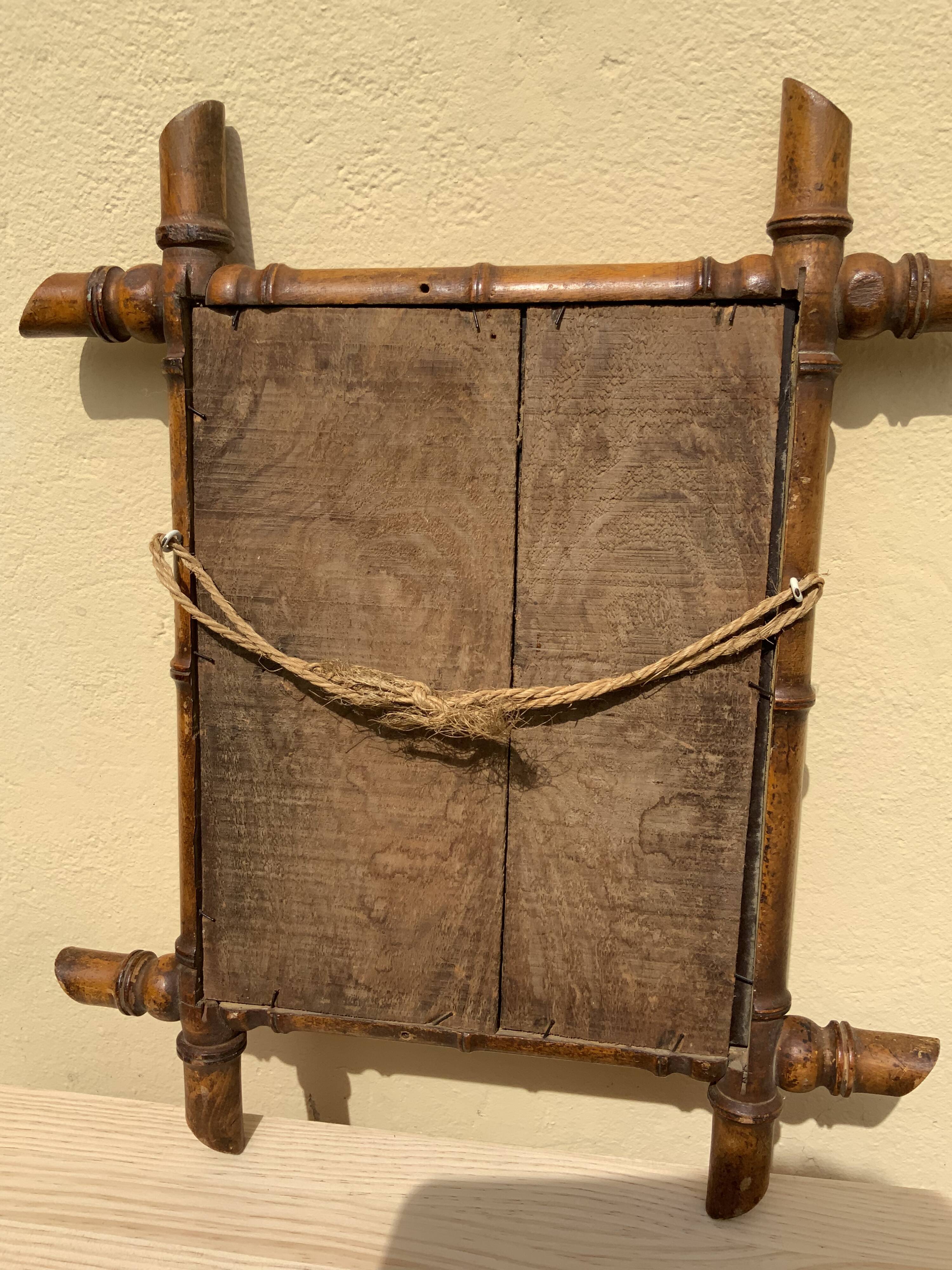 Vintage bamboo mirror in light wood bohemian decoration
