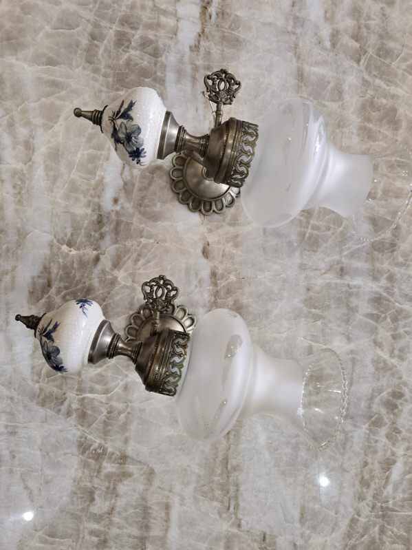 Pair of vintage wall sconces in brass, porcelain, and frosted glass.