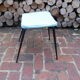 Vintage stool with tapered legs in sky blue faux leather.