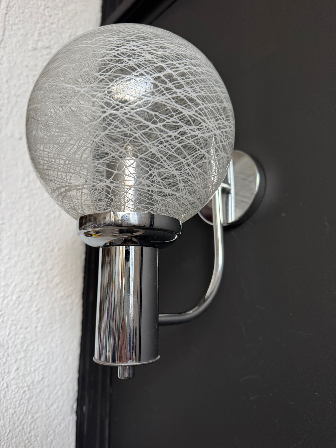 Chrome wall light with blown glass from the 1970s.