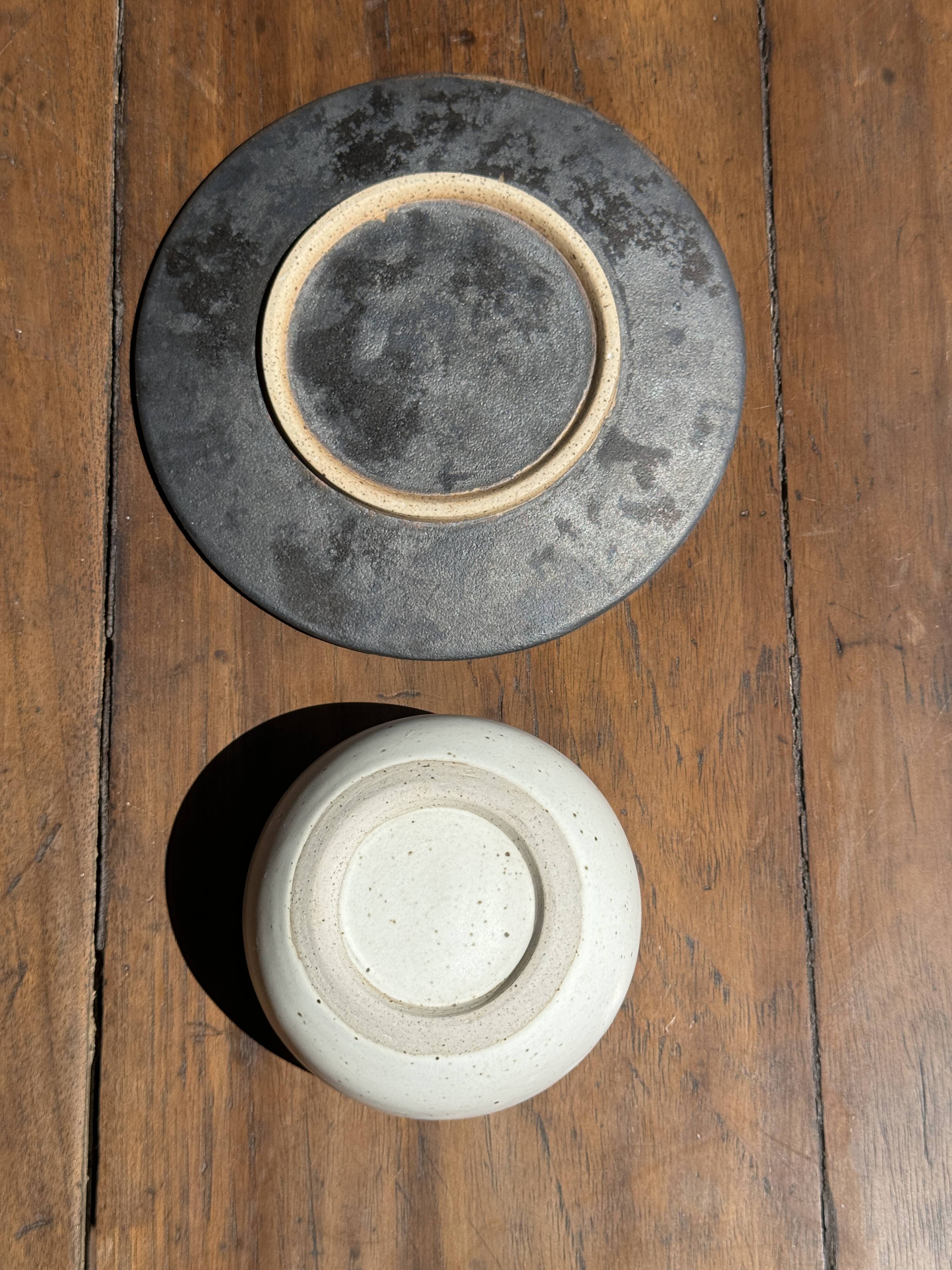 White Indonesian ceramic cup and gray saucer