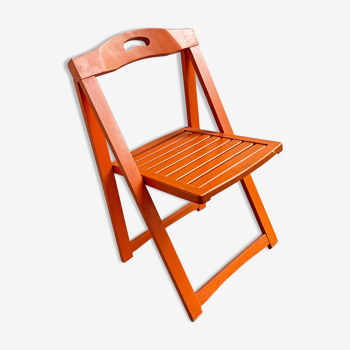 Vintage orange wooden folding chair with a slat seat