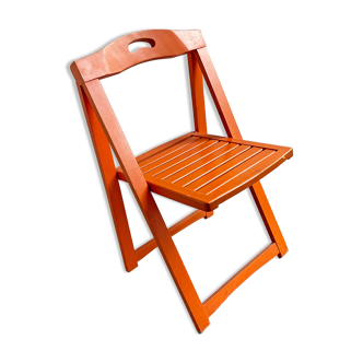 Vintage orange wooden folding chair with a slat seat
