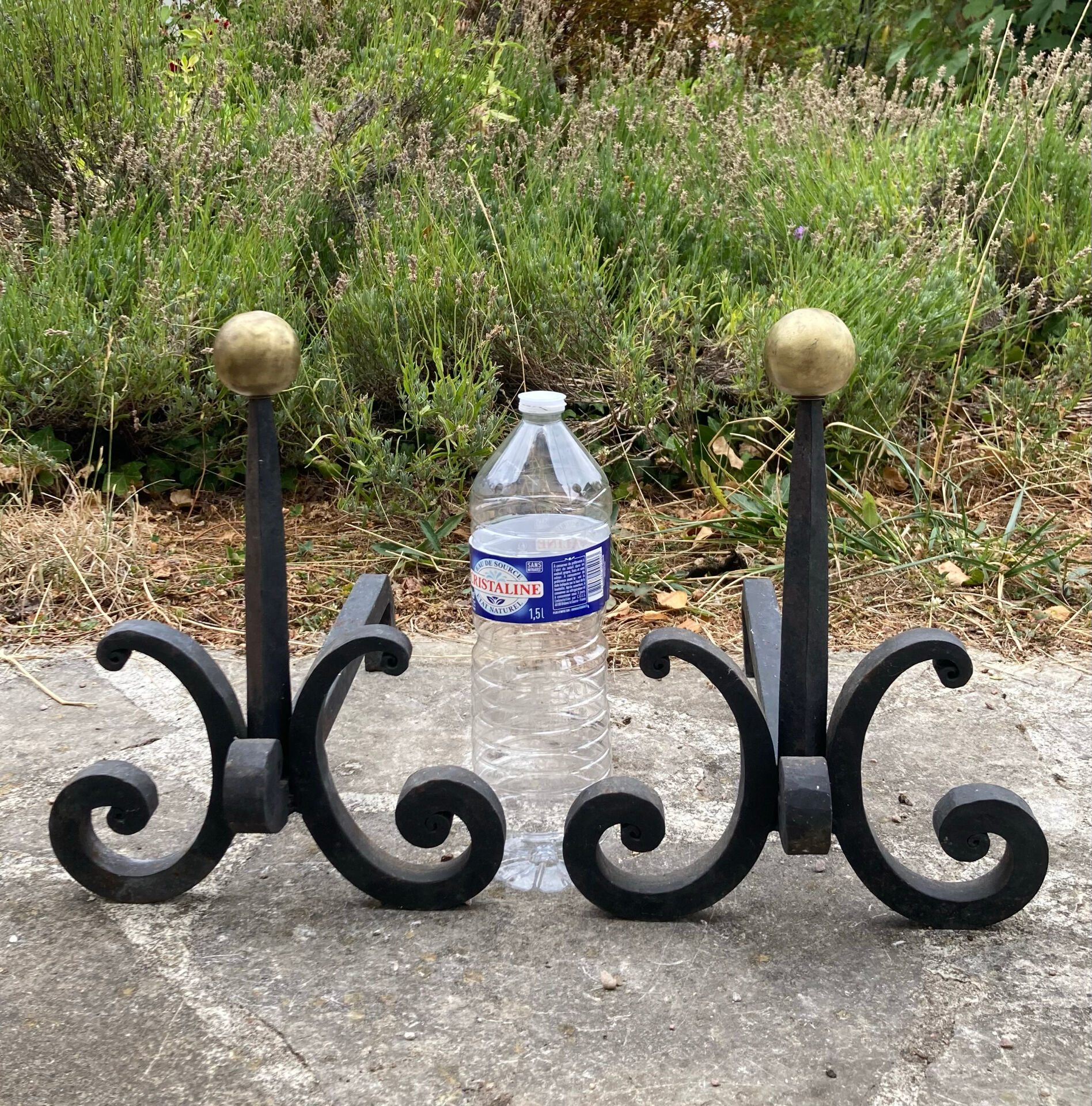 Massive wrought iron chenets from the 19th century topped with brass balls.