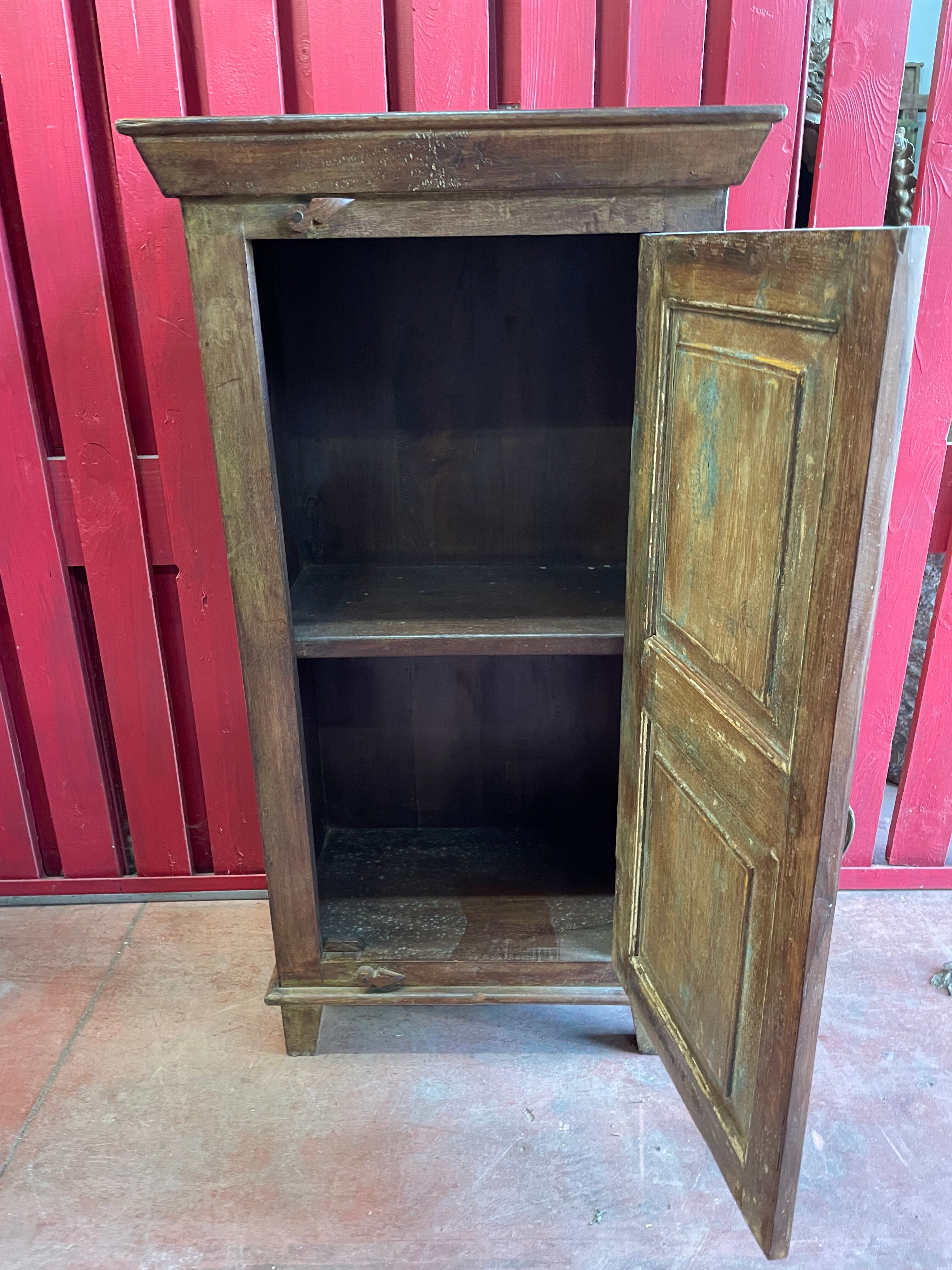 India. Bonnetière with a teak door finely carved by hand.