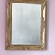 Richly carved antique gilded mirror