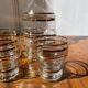Gold-rimmed decanter and liqueur glass service