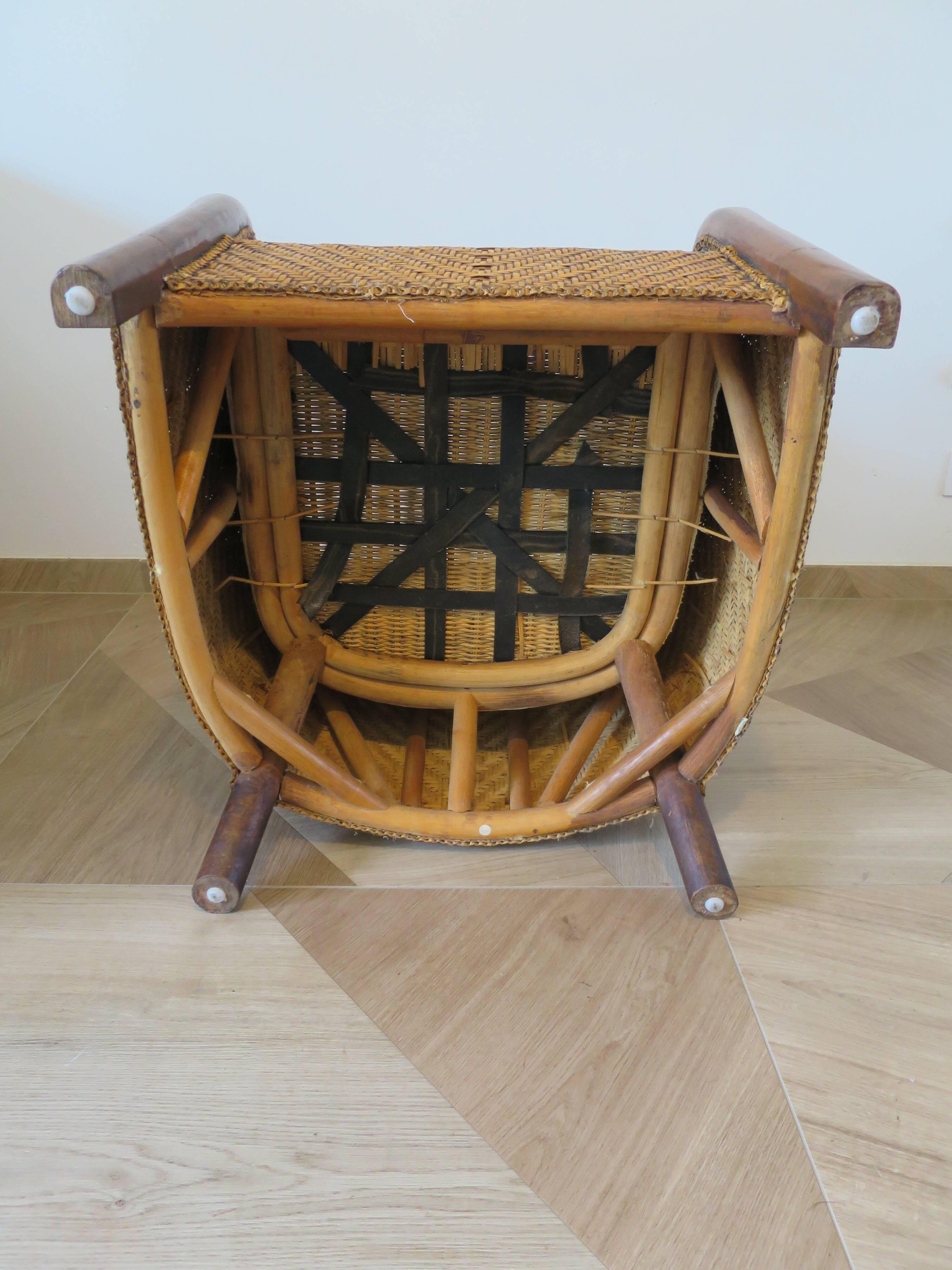 Colonial style armchair in woven rattan and exotic wood