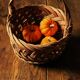 Round woven dark wicker basket with openwork vintage handle
