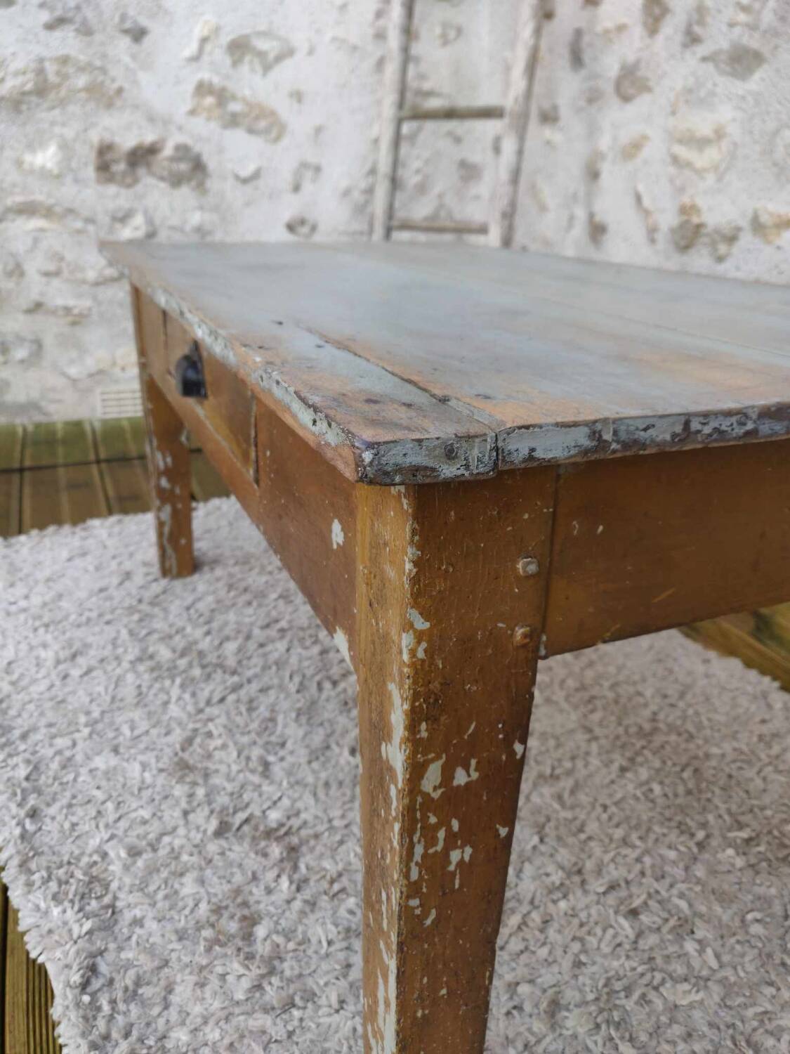 Patinated coffee table with a drawer