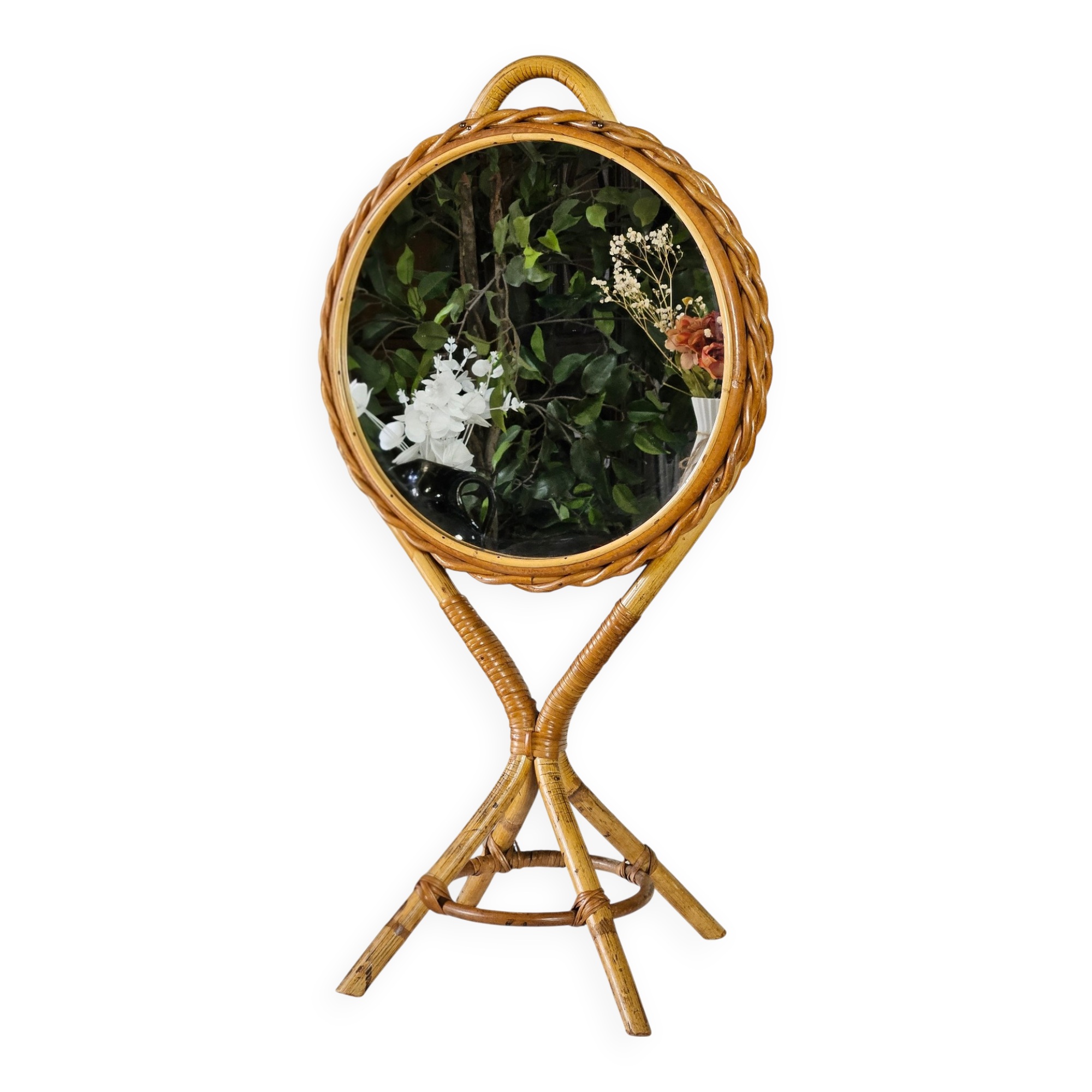 Vintage double-sided round mirror on a rattan stand.