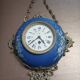 Wall clock in glazed earthenware decoration and brass chain empire style