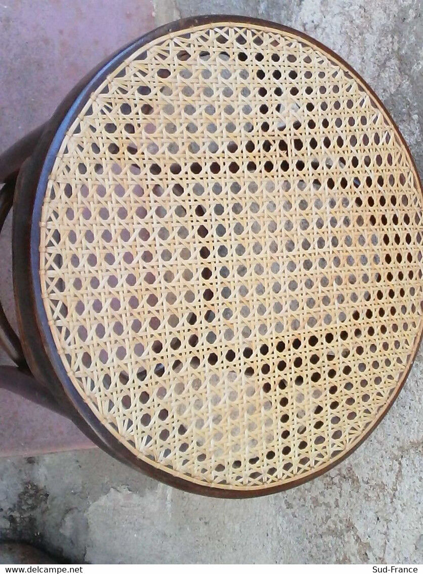 Low stool with canned seat and curved wood
