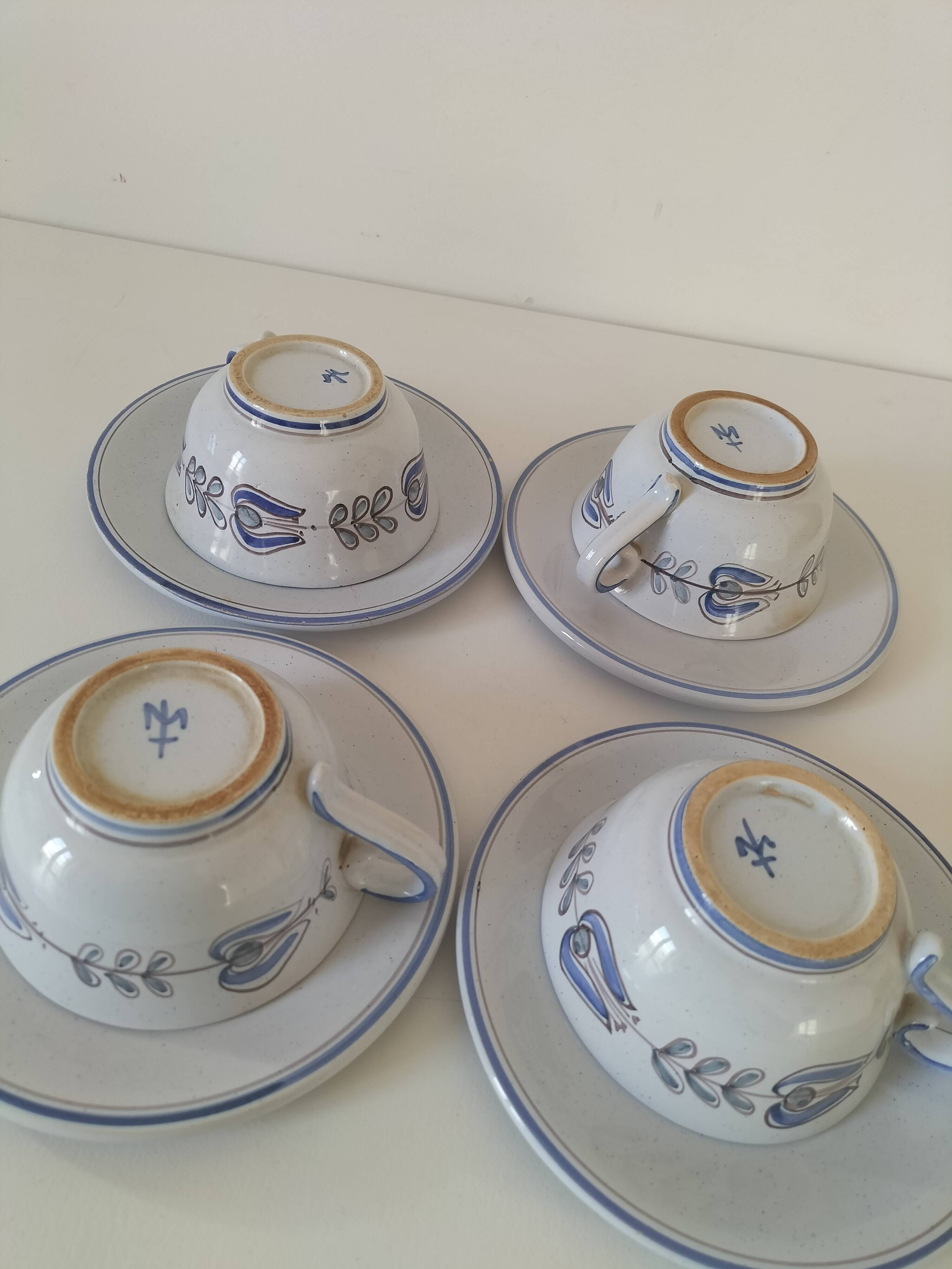 Glazed earthenware cups and saucers