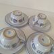 Glazed earthenware cups and saucers