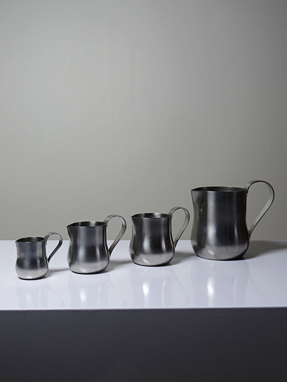 Set of 4 vintage bar measures in brushed stainless steel from the 60s-70s.