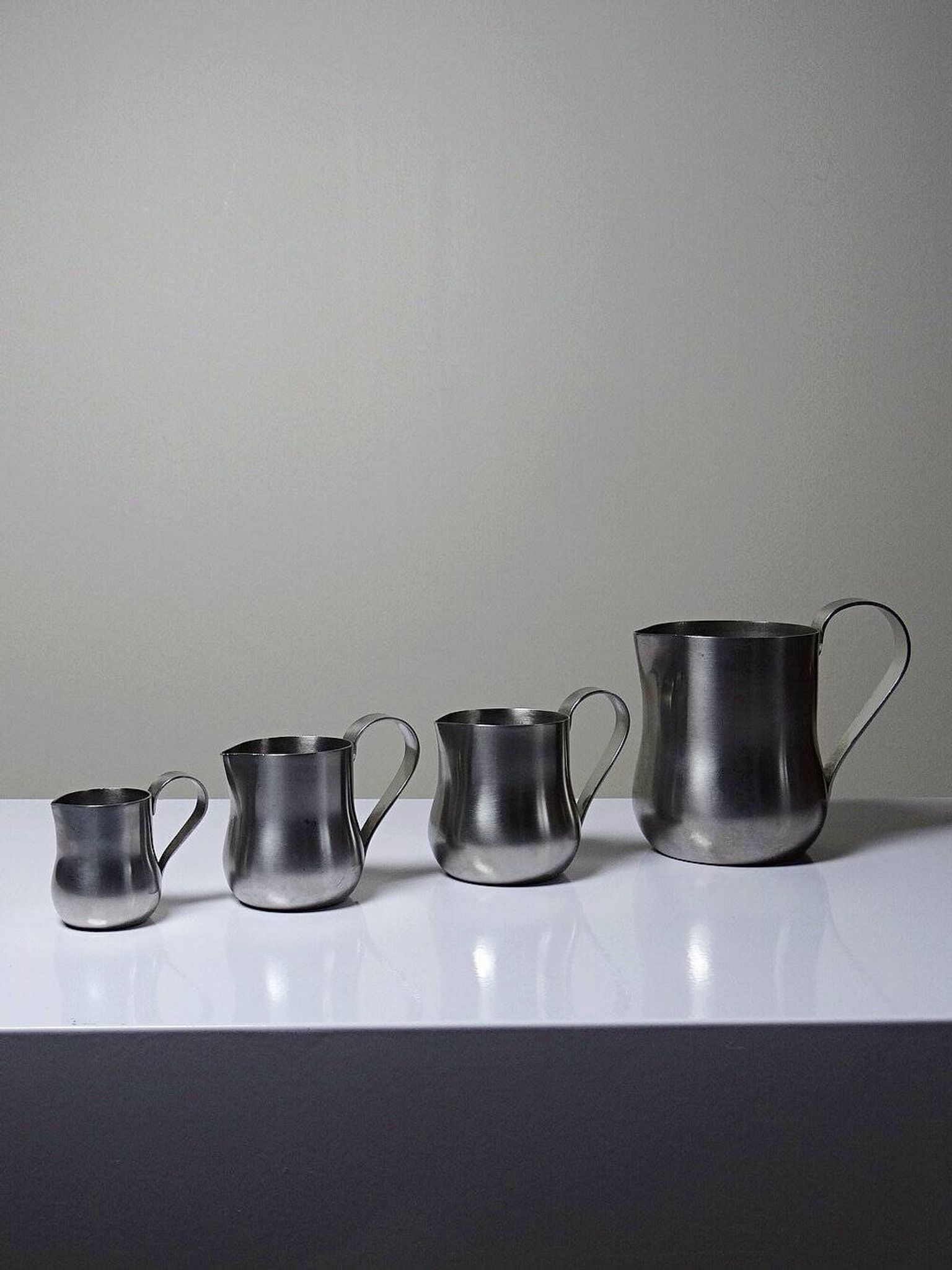 Set of 4 vintage bar measures in brushed stainless steel from the 60s-70s.