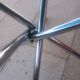 Round smoked glass table from the 70s. Foldable stainless steel legs.