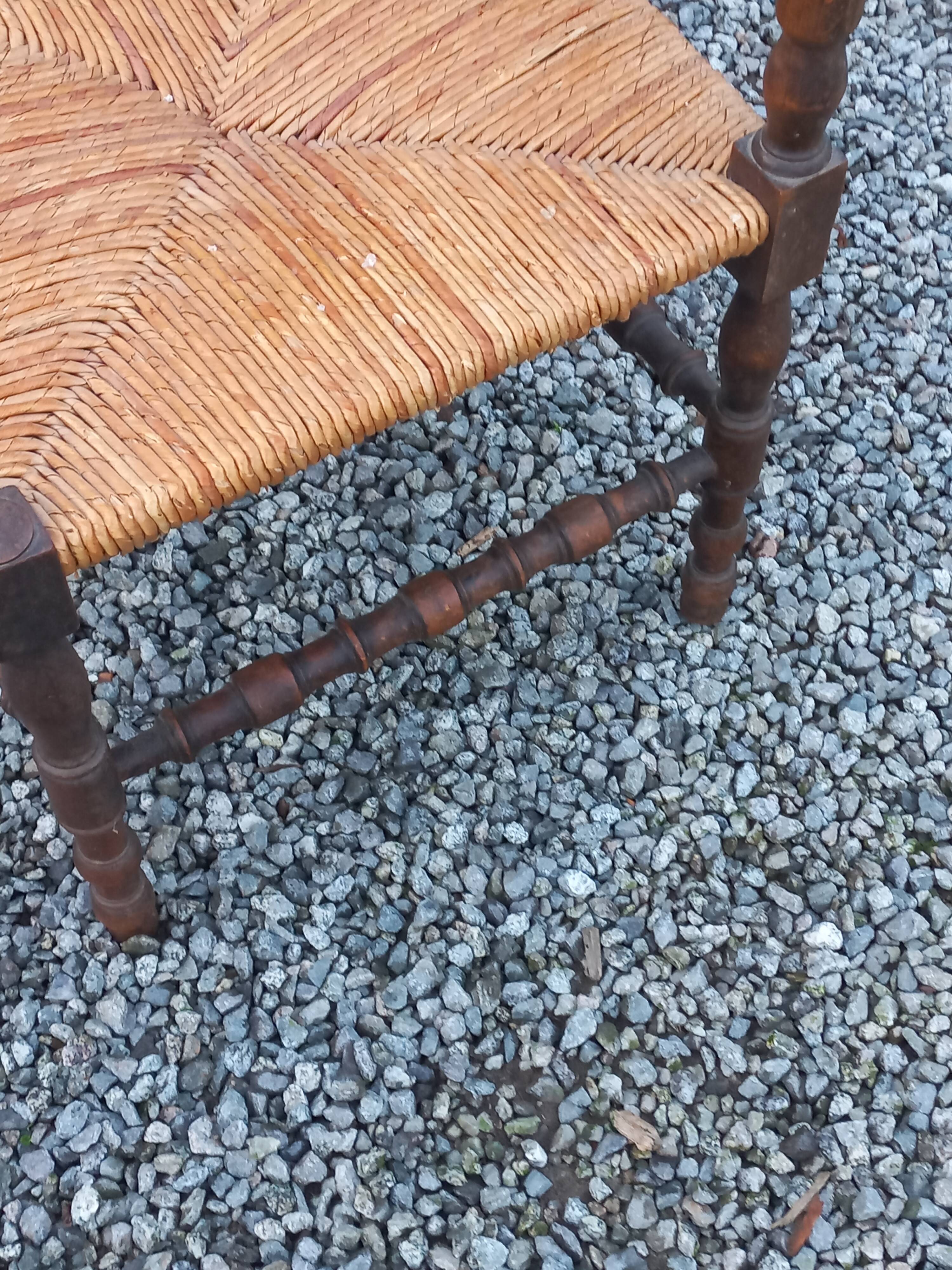 Pair of angled armchairs with turned wood and rush seats from the 1960s.