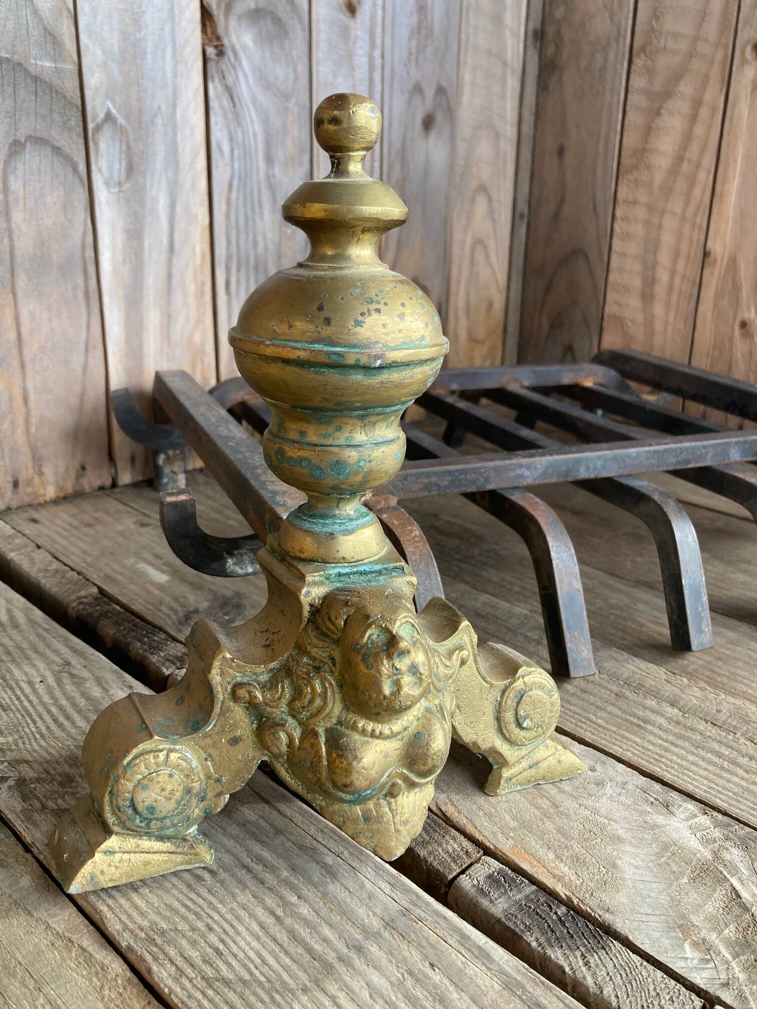 Pair of andirons and grates in cast iron and bronze with gilded grotesques, 17th century