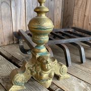 Pair of andirons and grates in cast iron and bronze with gilded grotesques, 17th century