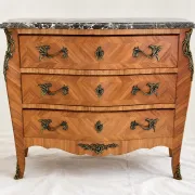 Curved Louis XV style commode in marquetry, veined marble and ornamentation.