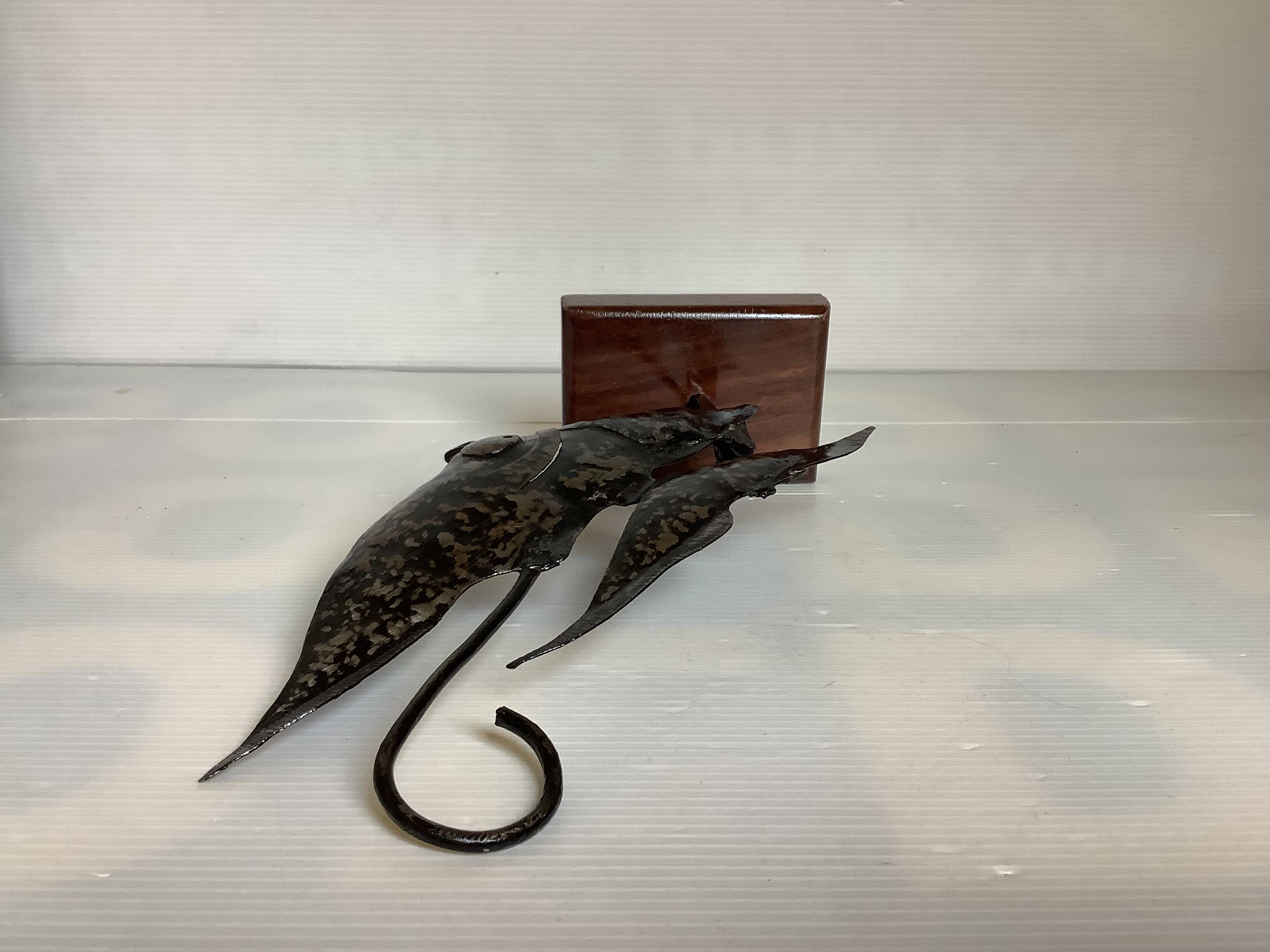 Small metal and wood fish statue