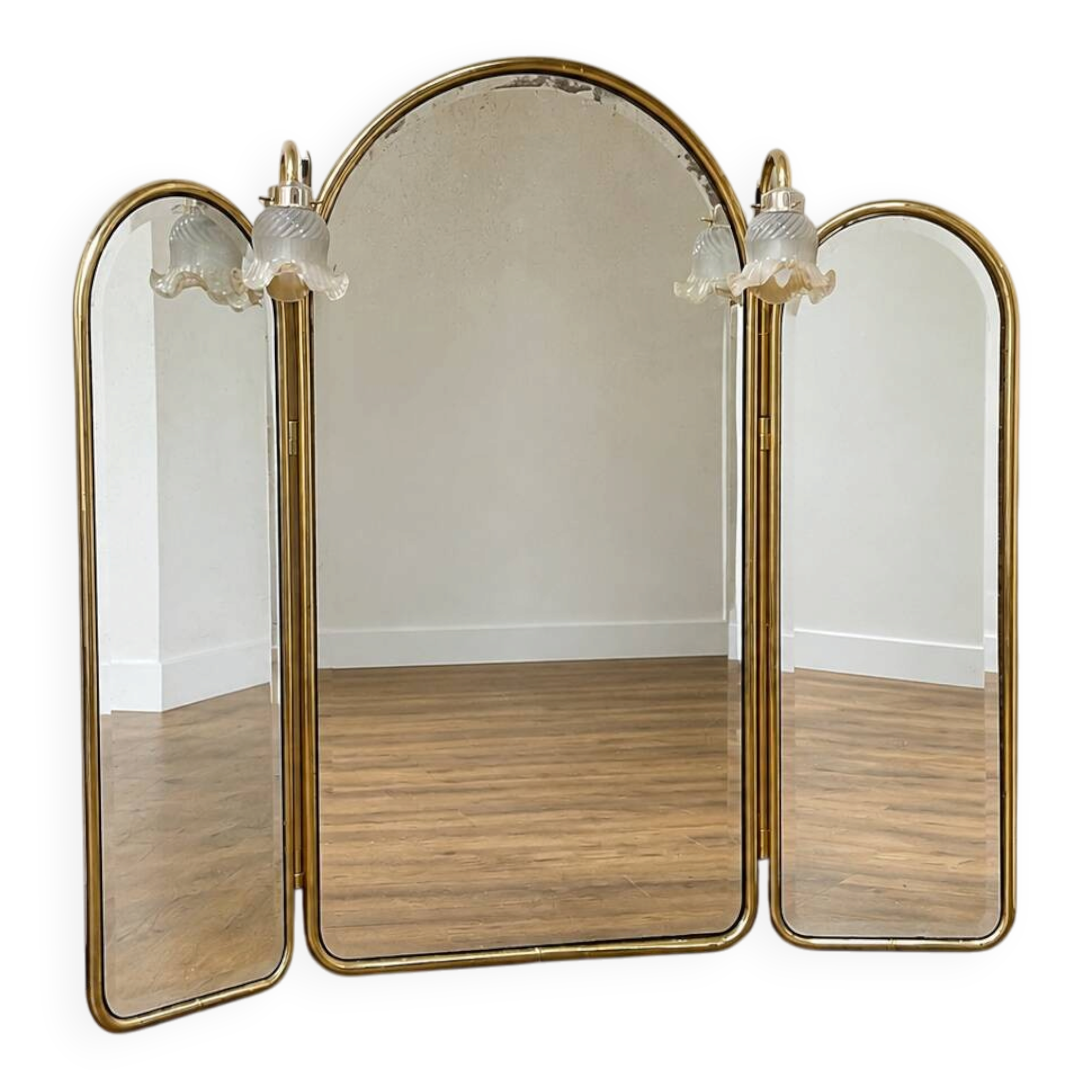 Vintage triptych mirror in brass with wall lights.