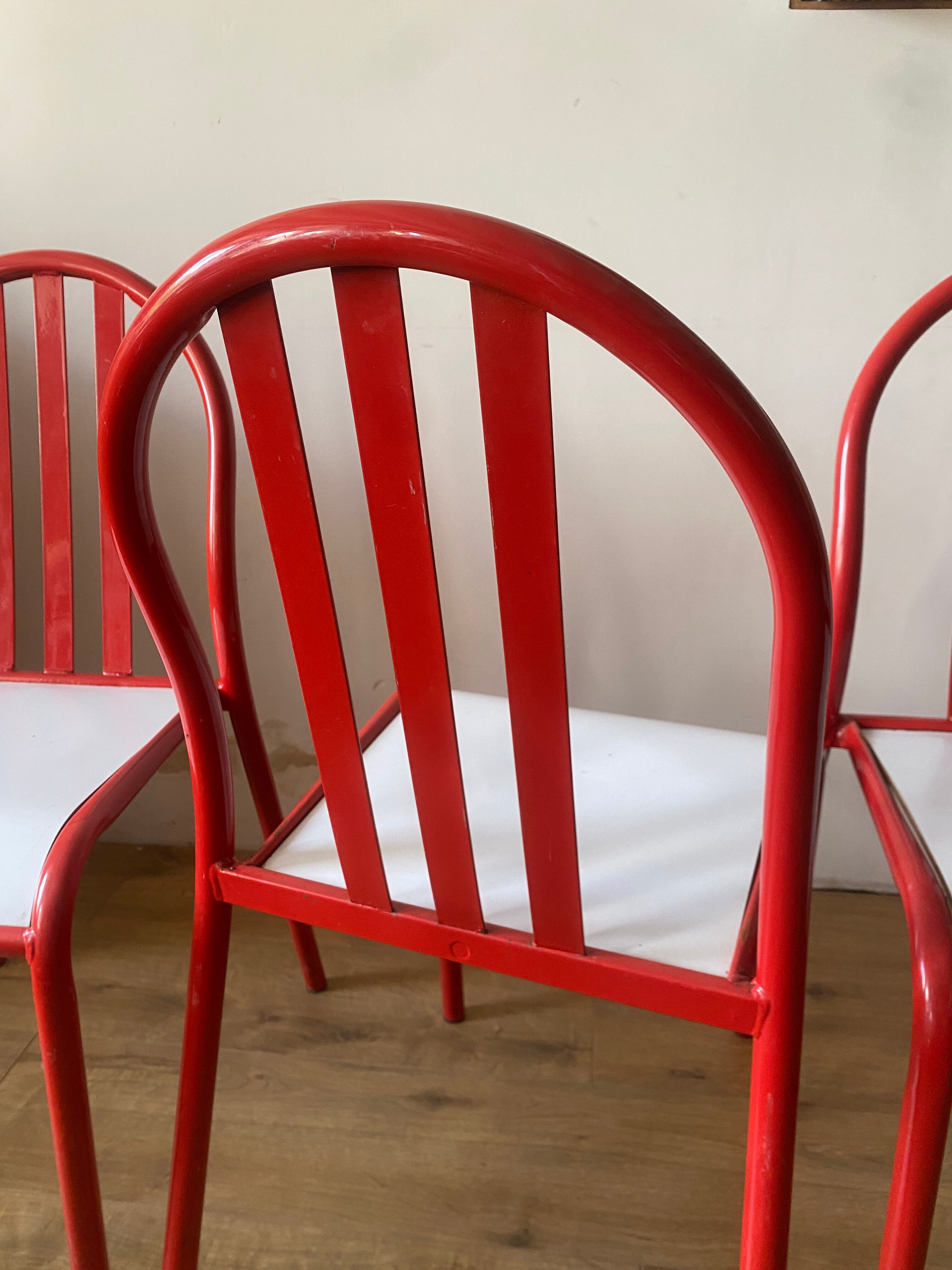 4 red metal chairs by Mallet-Stevens