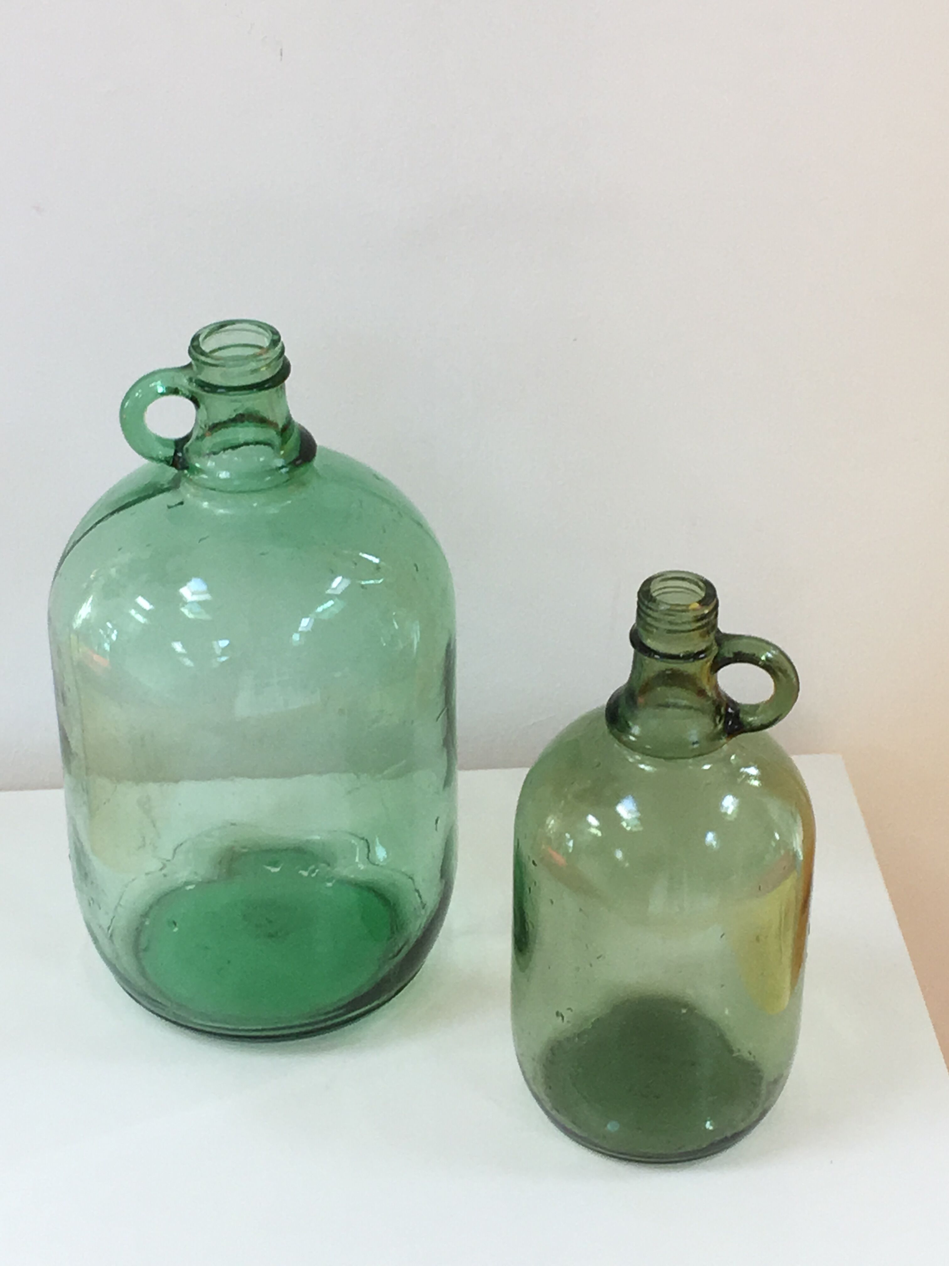 Pair of old demijohn bottles